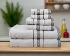 a stack of towels sitting on top of a wooden table