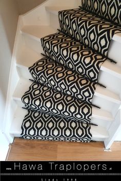 some black and white pillows sitting on top of a set of stair treads in a house