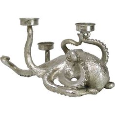 an octopus candle holder with two candles in it's mouth and one on its back