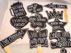 black and white photo of graduation party signs with wooden sticks in the shape of speech bubbles