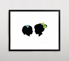 the silhouettes of two women with bows on their heads are framed in black and white