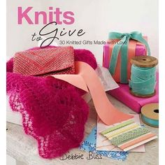 the cover of knits for give, featuring pink and green items on a table