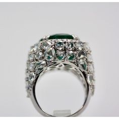 This is part of Chairish’s Fine Jewelry assortment.  Oval Emerald 12.25 Carat Diamond Surround 8.85 Carat Total Weight 21.10 Carat  This oval Emerald weights in at 12.25 carats and is a gorgeous Emerald Green with transparency. The Diamonds weigh in at 8.85 Carats and the mount is exceptional the Diamonds are VS1-VS2 and G-J in color. This is a bombe mount. The shoulders of the ring are embellished with baguette cut Diamonds in the center border with a perimeter of round cut Diamonds accents. Th Luxury Marquise Emerald Ring, Luxury Pear-shaped Emerald Ring For Formal Occasions, Exquisite Oval Emerald Ring In Platinum, Luxury Oval Emerald Ring With Brilliant Cut, Luxury Evening Rings With Gemstone, Platinum Oval Emerald Ring With 17 Jewels, Oval Platinum Emerald Ring With 17 Jewels, Formal Pear-shaped Emerald Ring In White Gold, Luxury Pear-shaped Diamond Ring With 17 Jewels