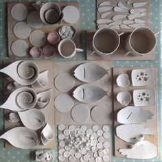 several pieces of pottery are laid out on a table with polka dot paper and wooden trays