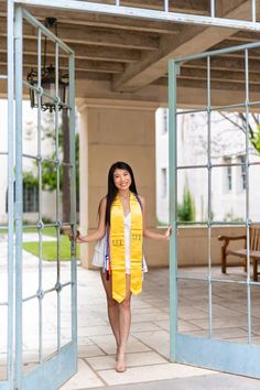 a woman wearing a yellow scarf standing in an open doorway