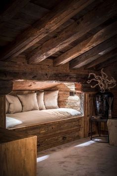 a room with wooden walls and beams on the ceiling