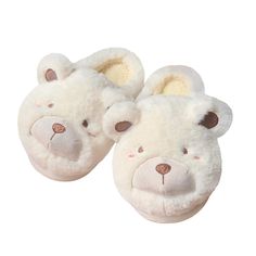 a pair of white slippers with a teddy bear face