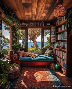 a room with a bed, bookshelf and plants on the floor in front of a window