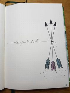 an open notebook with arrows and the word peace written in cursive writing on it