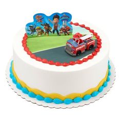 a birthday cake with a firetruck and cars decoration on the top is shown