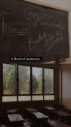 an empty classroom with chalk writing on the blackboard