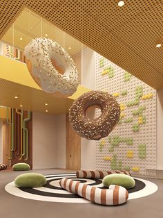 there are two donuts hanging from the ceiling in this modern office building with circular carpeting