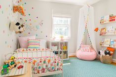 a child's bedroom decorated in pastel colors