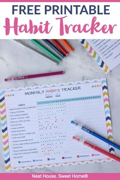 a free printable habit tracker is shown with markers and pencils on the table