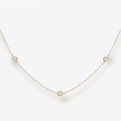 This head-turning necklace features ten bezel-set round brilliant diamonds spaced in the classic "By the Yard" style. Wear it solo, layer it, or add a pendant to elevate your look. It could easily become the most versatile necklace in your collection. Curate an eye-catching statement look by matching this with some of the other natural beauties from our Diamond Jewelry Collection. Natural Diamonds: 0.95ctw 14K Yellow Gold Length: 20 Inches Luxury Timeless Yellow Gold Diamond Necklace, Tiffany Diamond Necklace, Brilliant Diamond, Round Brilliant, Bezel Setting, Diamond Jewelry, Natural Diamonds, Yard, Jewelry Collection