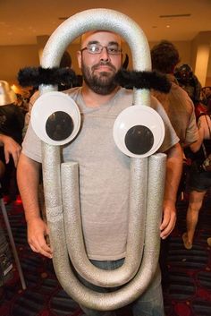 a man is standing in a room with some weird things on his head and eyes