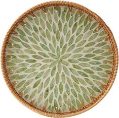 a wicker basket with green leaves painted on it