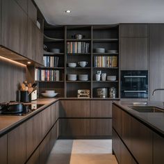 a kitchen with wooden cabinets and shelves filled with plates, bowls and utensils