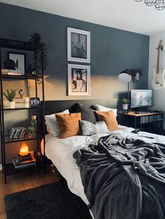 a bedroom with grey walls and pictures on the wall