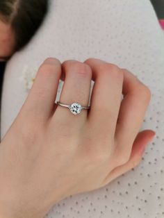 a close up of a person wearing a ring