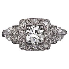 an antique style diamond ring with filigrees on the shoulders and sides, set in