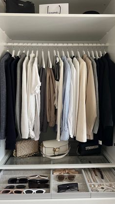 an organized closet with clothes and shoes