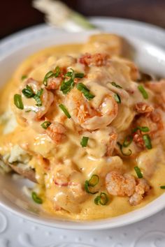 a white plate topped with pasta and shrimp