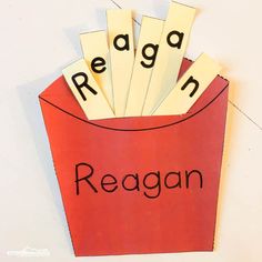 a red paper bag with the word reagan in it and some cut outs on top