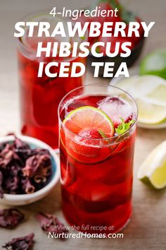 strawberry hibiscus iced tea with lemons and mint on the side, in front of