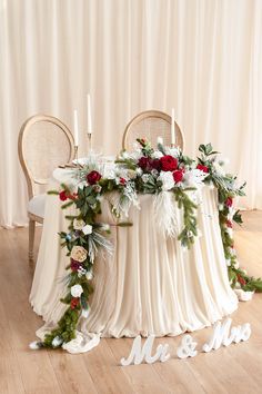 the table is decorated with flowers and greenery for an elegant winter wedding at mr and mrs