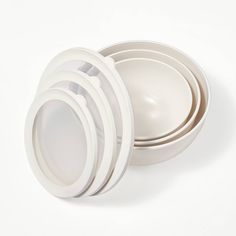 four white bowls stacked on top of each other with one empty bowl in the middle