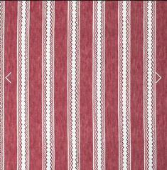 a red and white striped rug with an arrow on it