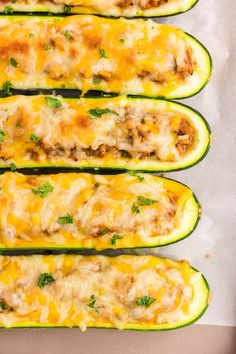 four zucchini boats with meat and cheese on them