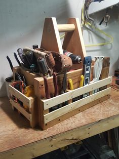 a wooden box filled with tools on top of a table