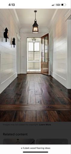 an image of a hallway with wood flooring on the front and back walls, which is