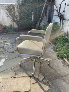 three office chairs sitting on top of a stone patio