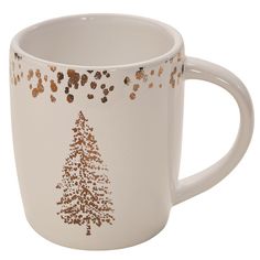 a white coffee mug with gold glitter trees on it