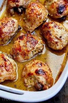 chicken thighs in a white casserole dish ready to be cooked for dinner or as an appetizer