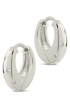 Brightly polished hoops are highlighted further by round-cut cubic zirconia that lend a dose of shine to any ensemble. 0.6" hoop diameter; 0.2" width Hinge with snap-post closure Rhodium plate/cubic zirconia
 Imported Silver Diamond Huggie Earrings Tarnish Resistant, Silver Diamond Tarnish-resistant Huggie Earrings, Modern Round Cubic Zirconia Huggie Earrings, Modern Cubic Zirconia Huggie Hoop Earrings, Modern Round Cubic Zirconia Hoop Earrings, Modern Cubic Zirconia Hoop Earrings, Modern Cubic Zirconia Hoop Earrings In Diamond White, Modern Diamond White Cubic Zirconia Hoop Earrings, Modern Huggie Earrings In Diamond White Cubic Zirconia