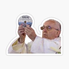 a sticker depicting the pope holding up a cd in one hand and looking at it