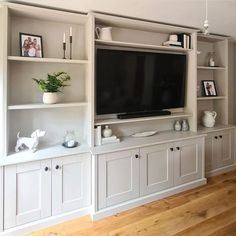 an entertainment center with built - in cabinets and a flat screen tv on the wall