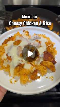 mexican cheesy chicken and rice on a white plate being held by a person