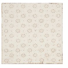 a white rug with small flowers on the top and bottom, against a white background