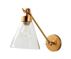 an antique brass wall light with clear glass shade and gold metal fittings on the arm