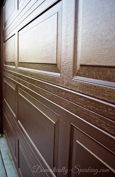 a close up of a brown door on the side of a building