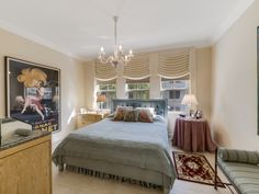 a bed room with a neatly made bed next to a window