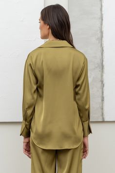 Our Olive Satin Long Sleeve Blouse is a must-have for every wardrobe. The rich, luxurious satin fabric adds a touch of elegance to any outfit, while the classic olive color is timeless and versatile. Perfect for any occasion, this blouse will quickly become your go-to choice for effortless style and sophistication. Olive Satin Long Sleeve Blouse Color - Light Olive Green Polyester Made in Vietnam Satin Button Up, Buckle Bags, Satin Long Sleeve, Denim Outerwear, Stylish Top, Half Zip Sweatshirt, Jumpsuit Shorts Rompers, Button Up Top, Olive Color