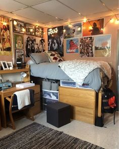 a bed room with a neatly made bed and lots of pictures on the wall