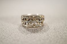 I am offering you this vintage sterling silver wedding band stacker design ring.  This features several genuine marcasite stones in a raised relief diamond shaped design. It is currently a size 7.5, though I am sure it could be sized up or down. Please review all of my pictures, as they are all a very important part of , my listing/descriptions. Victorian Silver Jewelry With Decorative Band, Vintage Silver Filigree Ring With Diamond Accents, Classic Silver Stackable Rings With Rose Cut Diamonds, Antique Silver Filigree Ring With Rose Cut Diamonds, Silver Diamond Ring With Decorative Band, Ornate Silver Diamond Ring With Rose Cut Diamonds, Art Deco Silver Rings With Rose Cut Diamonds, Antique Silver Ornate Rings For Anniversary, Elegant Silver Stackable Rings With Rose Cut Diamonds