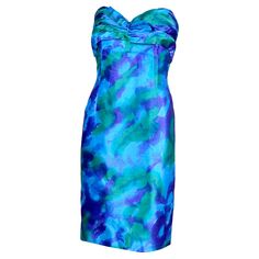 This beautiful Loris Azzaro Paris vintage watercolor silk strapless cocktail or party dress was made in France in the 1980's. This stunning dress is in rich saturated shades of blue, deep purple and green. The bodice has a built in bra and the dress closes with a back zipper. We especially love the pleats at the bust and the dramatic bow! This would be a perfect dress to wear to any Spring or Summer special event! We estimate that this dress will fit an approximate size XS but please use the mea Loris Azzaro, Dusty Pink Bridesmaid Dresses, Vintage Dress Blue, Dress Paris, Summer Cocktail Dress, Blue Polka Dot Dress, Vintage Watercolor, Prom Dresses Gowns, Silk Chiffon Dress